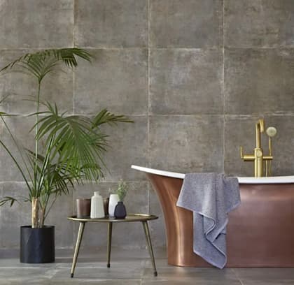 metal effect bathroom tile with a bath and a plant